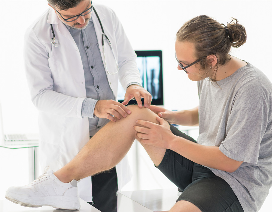Doctor examining patient knee