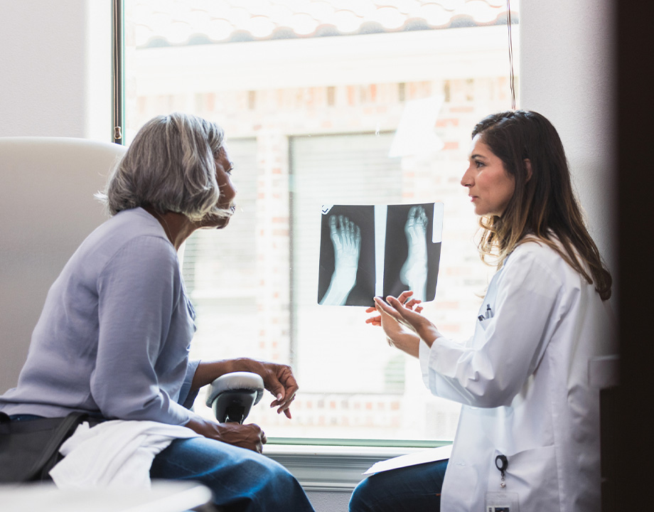 Doctor showing feet xray results to a patient