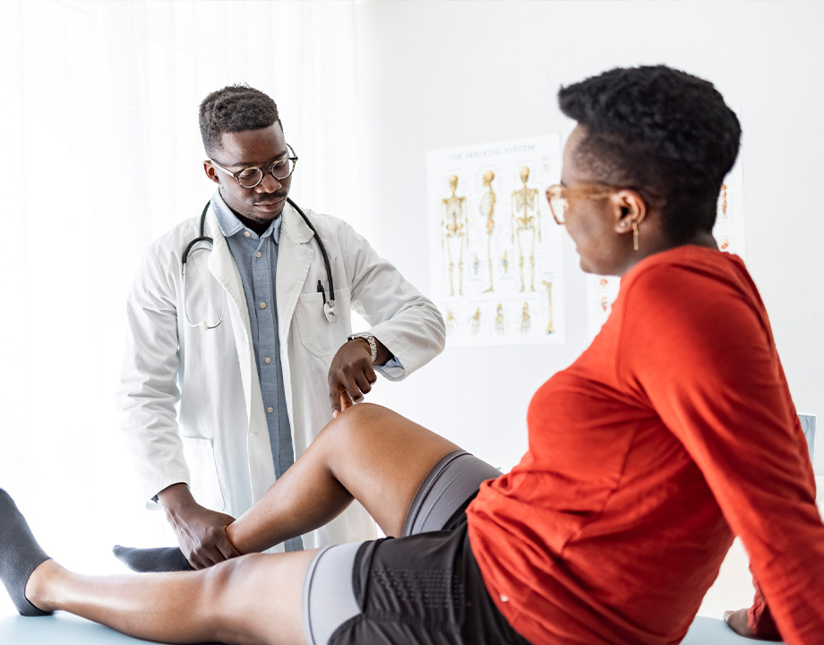 Doctor touching patient knee