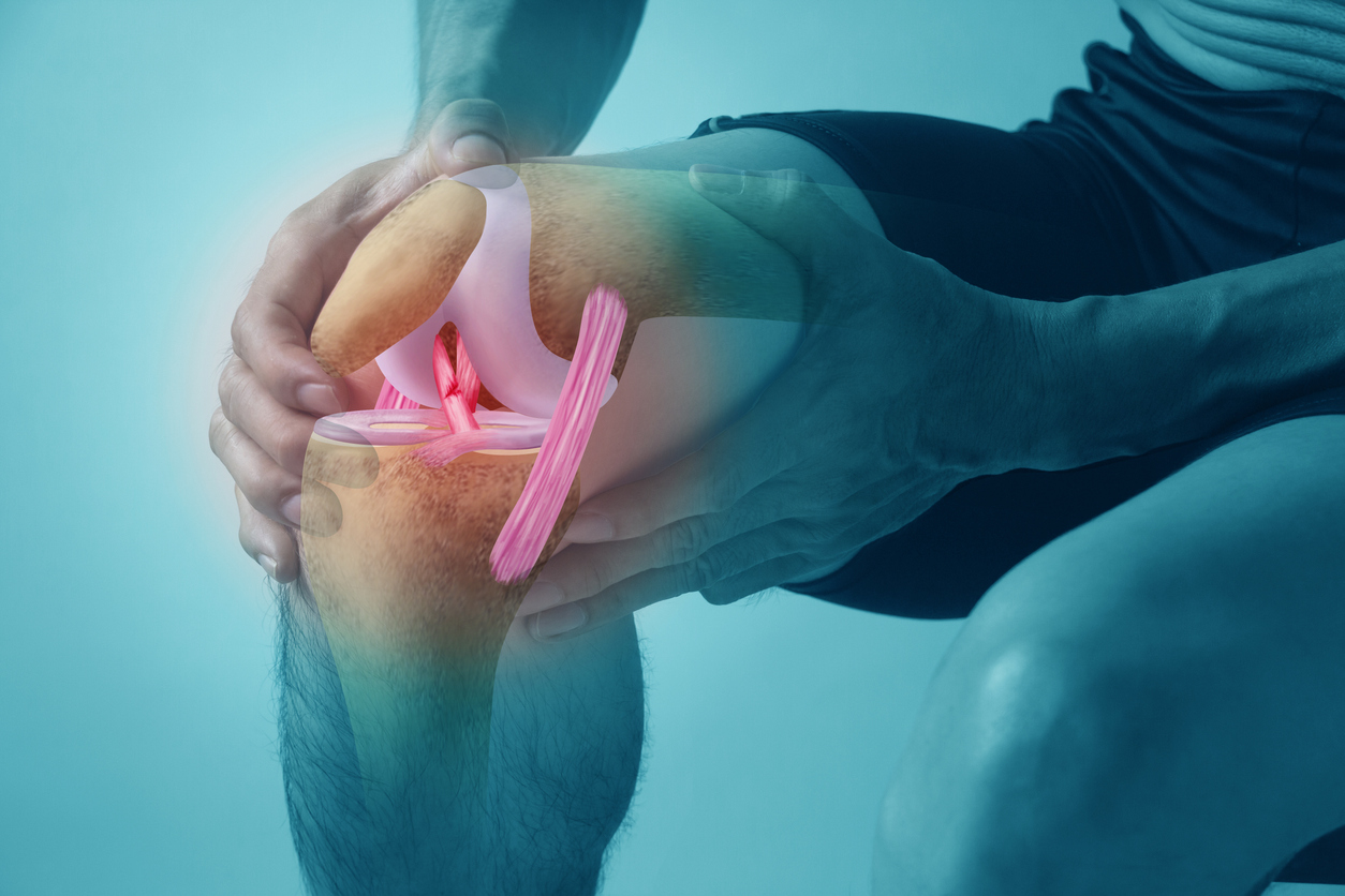 A man with an ACL tear holds his knee in discomfort as he considers waiting out the pain or starting rehab.