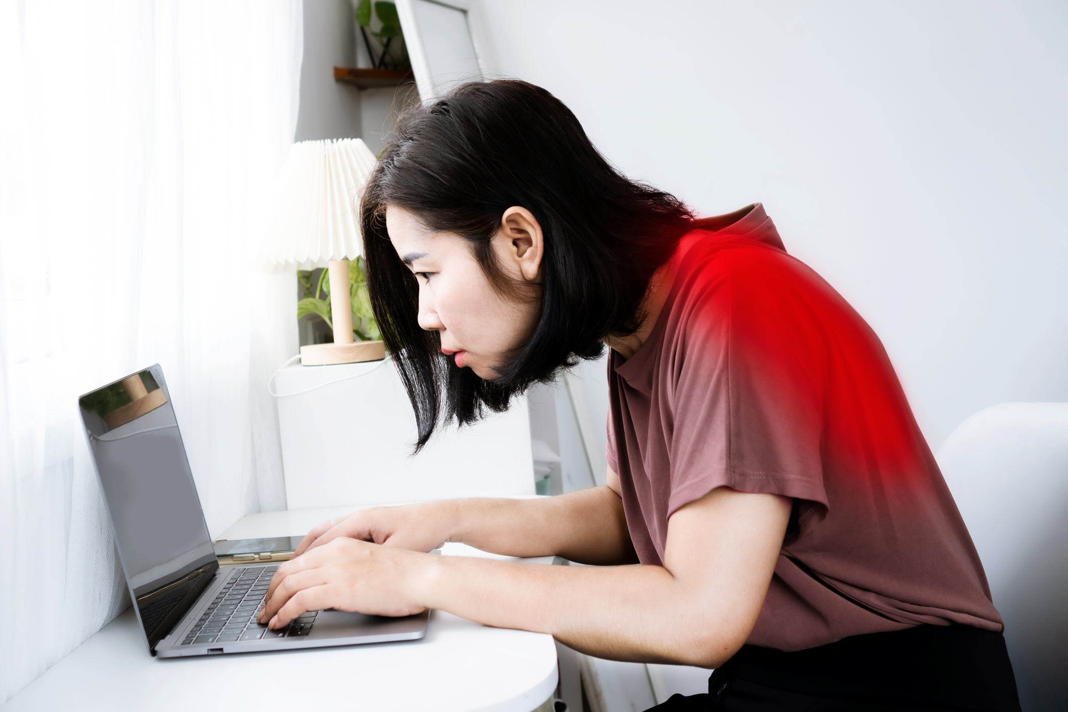 A person sitting at a desk with poor posture, illustrating how everyday habits can affect joint health over time.